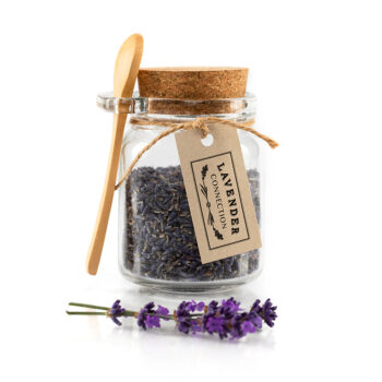 culinary lavender bud in glass jar with cork lid and wooden spoon