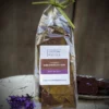 clear plastic gift bag of lavender chocolate bark, tied with green raffia