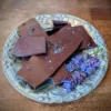 lavender chocolate bark laying on silver plate with sprigs of lavender