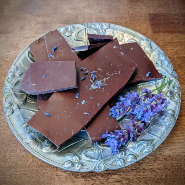 lavender chocolate bark laying on silver plate with sprigs of lavender